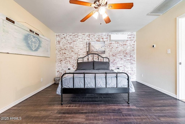 bedroom featuring ceiling fan, dark hardwood / wood-style flooring, and brick wall