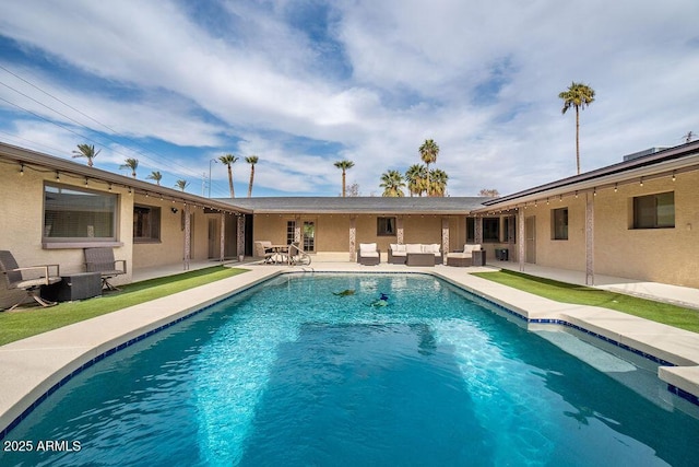 view of pool featuring outdoor lounge area and a patio