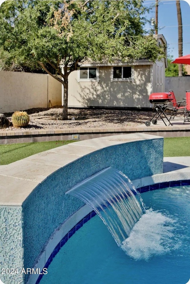 view of pool with pool water feature