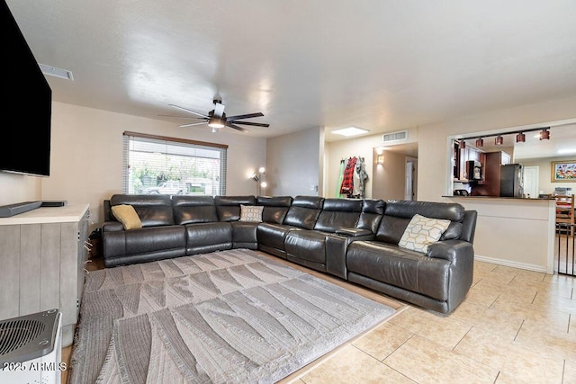 tiled living room with ceiling fan