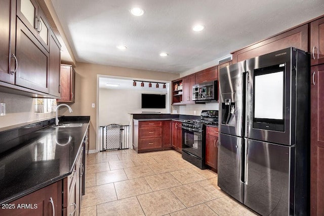 kitchen featuring light tile patterned flooring, sink, and appliances with stainless steel finishes