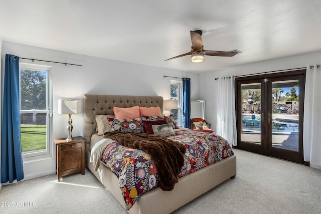 bedroom featuring access to outside, light colored carpet, and multiple windows