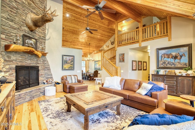 702 Flag Hollow Rd, Pinetop-Lakeside, AZ 85929 - living area with high vaulted ceiling, stairway, a fireplace, ceiling fan, and wood finished floors