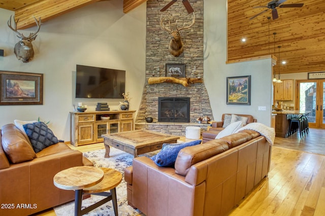 702 Flag Hollow Rd, Pinetop-Lakeside, AZ 85929 - living room with ceiling fan, a fireplace, high vaulted ceiling, wood ceiling with exposed beams, and light wood-type flooring
