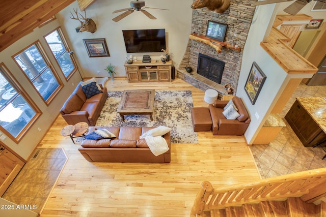702 Flag Hollow Rd, Pinetop-Lakeside, AZ 85929 - living area featuring a ceiling fan, hardwood / wood-style flooring, a fireplace, and baseboards
