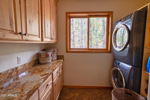 702 Flag Hollow Rd, Pinetop-Lakeside, AZ 85929 - laundry room with estacked washer and dryer, cabinet space, and baseboards