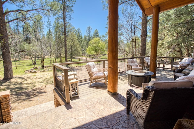 702 Flag Hollow Rd, Pinetop-Lakeside, AZ 85929 - view of patio / terrace with an outdoor living space with a fire pit and view of scattered trees