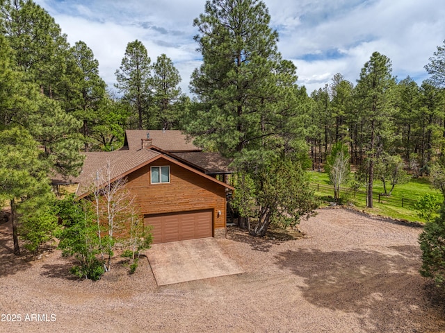 702 Flag Hollow Rd, Pinetop-Lakeside, AZ 85929 - rustic home with driveway and a garage