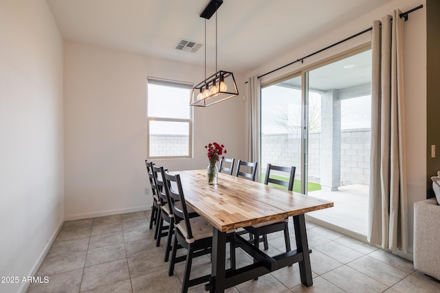 dining area featuring visible vents, light tile patterned flooring, a wealth of natural light, and baseboards