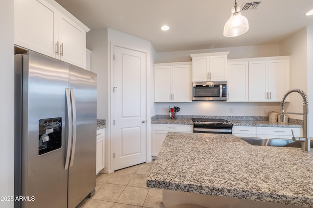 kitchen with white cabinets, visible vents, stainless steel appliances, and a sink