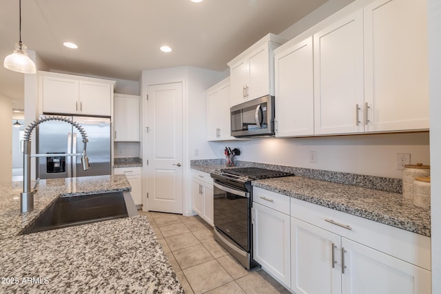 kitchen with stainless steel appliances, recessed lighting, white cabinetry, and a sink