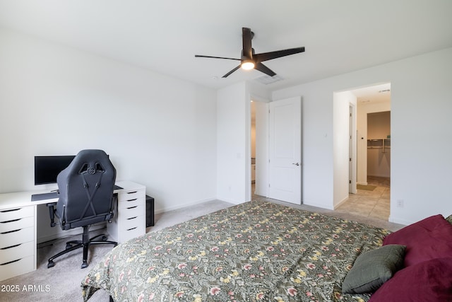 bedroom with baseboards, a ceiling fan, visible vents, and light colored carpet