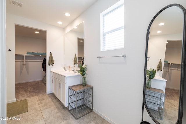 bathroom with visible vents, baseboards, tile patterned floors, vanity, and recessed lighting