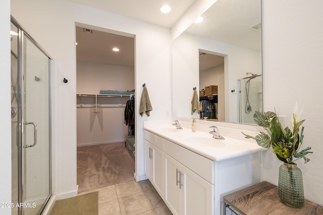 bathroom with a stall shower, tile patterned flooring, and a sink