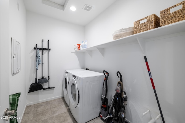 clothes washing area featuring light tile patterned floors, visible vents, attic access, separate washer and dryer, and laundry area