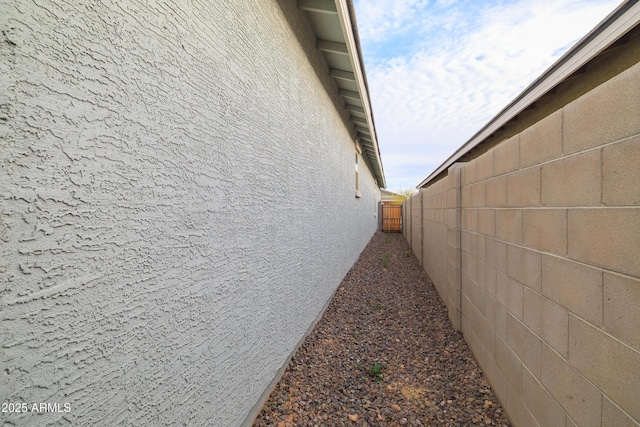 view of property exterior featuring fence and stucco siding