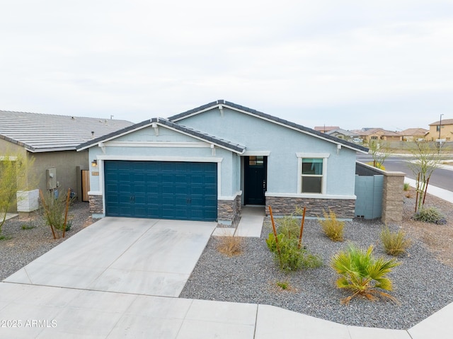 view of front of house with a garage, stone siding, driveway, and stucco siding