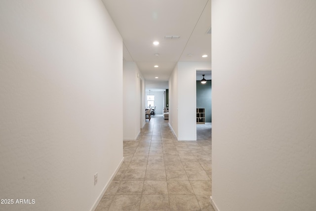 hall featuring light tile patterned floors, baseboards, visible vents, and recessed lighting