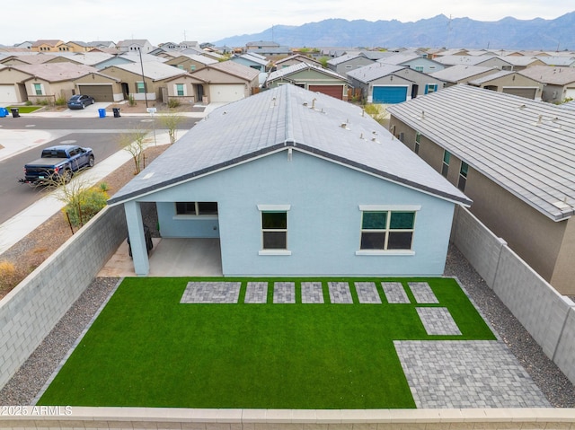 rear view of house featuring a lawn, a residential view, and a mountain view