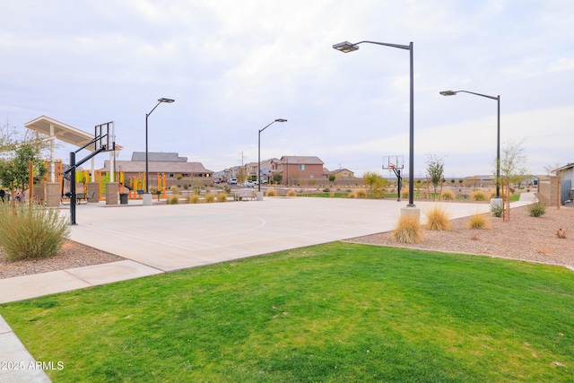 view of basketball court featuring community basketball court, a lawn, and a residential view