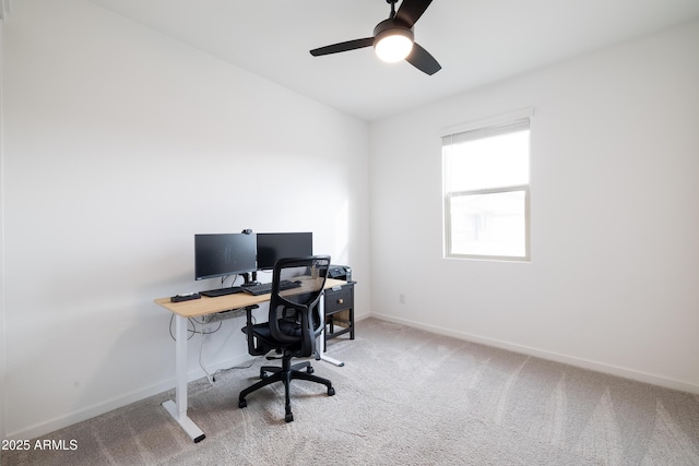 home office featuring carpet flooring, a ceiling fan, and baseboards