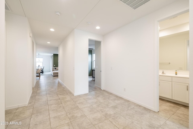 corridor featuring recessed lighting, visible vents, and baseboards