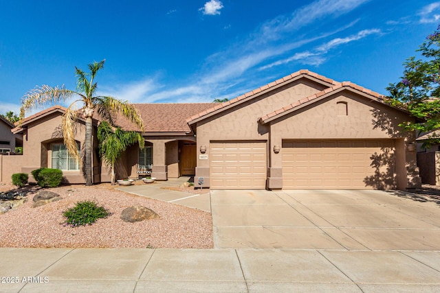 18021 N 53rd St, Scottsdale, AZ 85254 - ranch-style home featuring stucco siding, a garage, concrete driveway, and a tiled roof