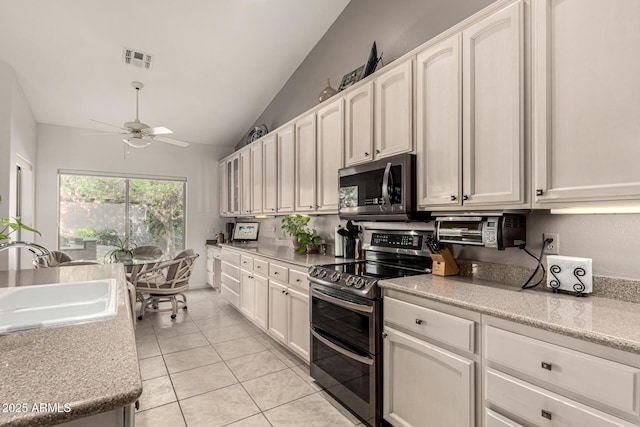 18021 N 53rd St, Scottsdale, AZ 85254 - kitchen featuring stainless steel appliances, a sink, ceiling fan, lofted ceiling, and white cabinetry