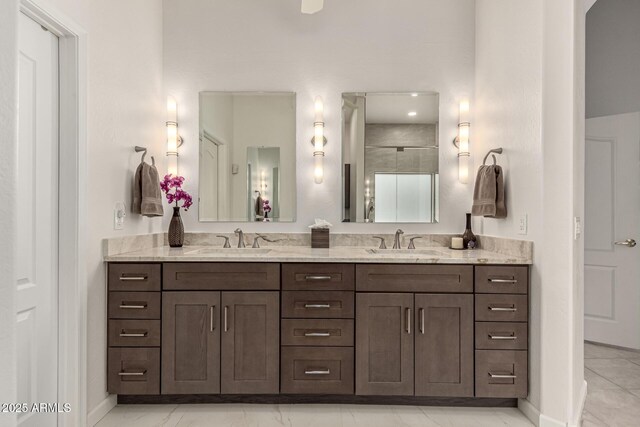 18021 N 53rd St, Scottsdale, AZ 85254 - full bathroom with marble look tile flooring, double vanity, baseboards, and a shower with door