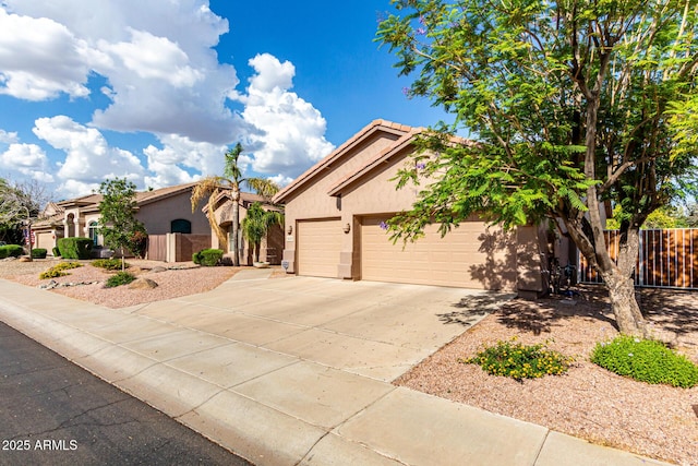18021 N 53rd St, Scottsdale, AZ 85254 - view of front of home featuring stucco siding, fence, driveway, an attached garage, and a tiled roof