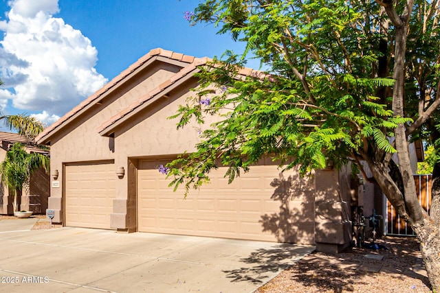 18021 N 53rd St, Scottsdale, AZ 85254 - view of front of home with stucco siding, driveway, a tiled roof, and a garage