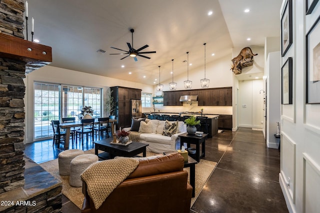 living room with ceiling fan and high vaulted ceiling