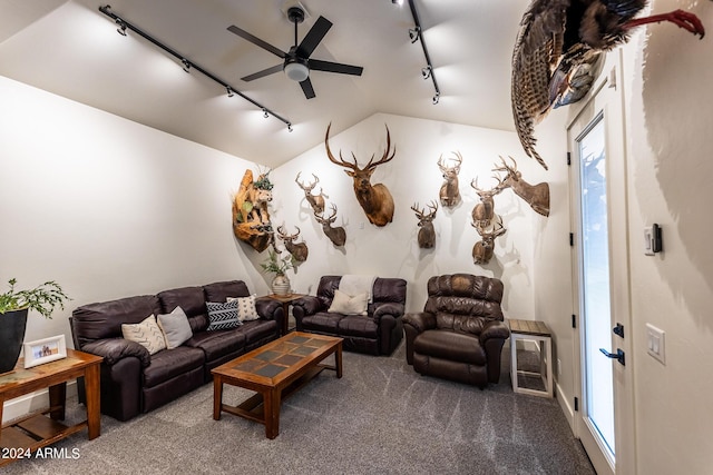 living room featuring vaulted ceiling, carpet, track lighting, and ceiling fan