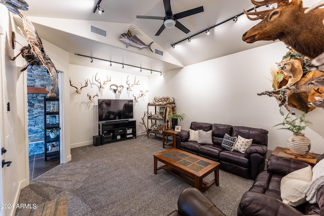 living room featuring lofted ceiling, carpet floors, track lighting, and ceiling fan