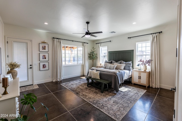 bedroom with access to outside, dark tile patterned flooring, and ceiling fan