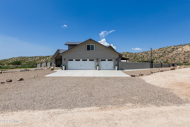 front facade with a mountain view and a garage