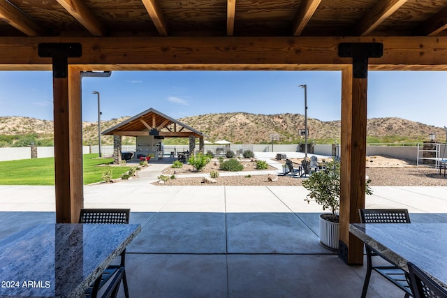 view of patio / terrace with a gazebo and a mountain view