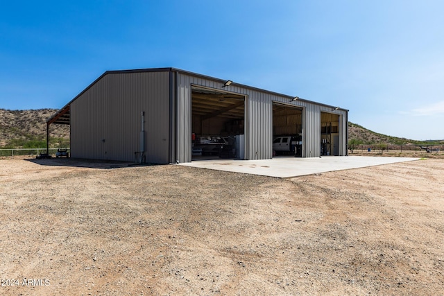 view of outdoor structure featuring a garage and a mountain view