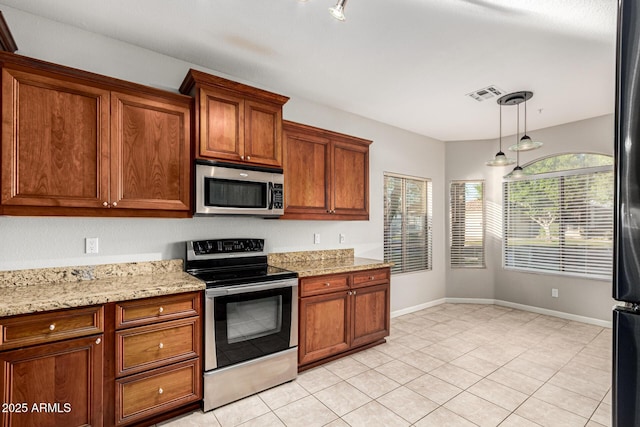 3152 N 83rd Pl, Scottsdale, AZ 85251 - kitchen featuring appliances with stainless steel finishes, light tile patterned floors, hanging light fixtures, and brown cabinetry