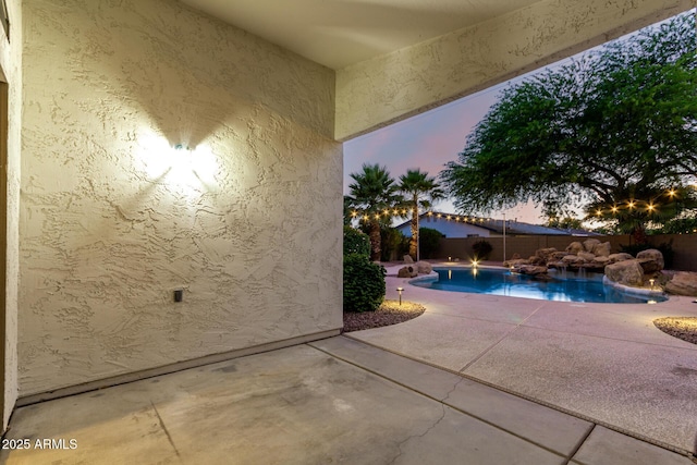 3152 N 83rd Pl, Scottsdale, AZ 85251 - pool at dusk with a patio area and a fenced backyard