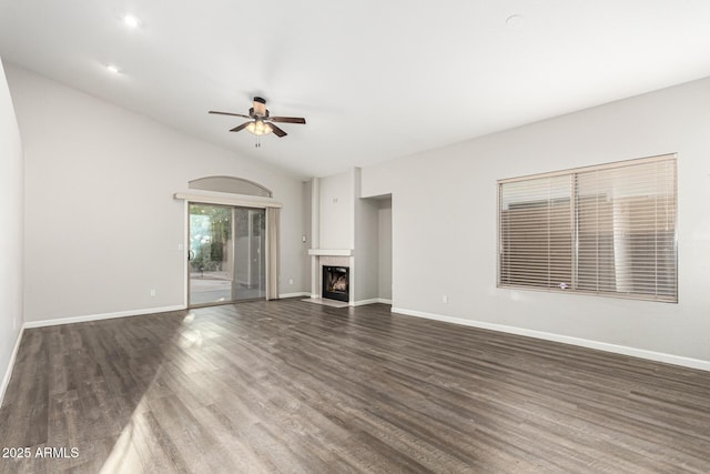 3152 N 83rd Pl, Scottsdale, AZ 85251 - unfurnished living room featuring a ceiling fan, wood finished floors, a fireplace with flush hearth, and lofted ceiling