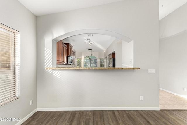 3152 N 83rd Pl, Scottsdale, AZ 85251 - unfurnished dining area featuring dark wood-style flooring and arched walkways