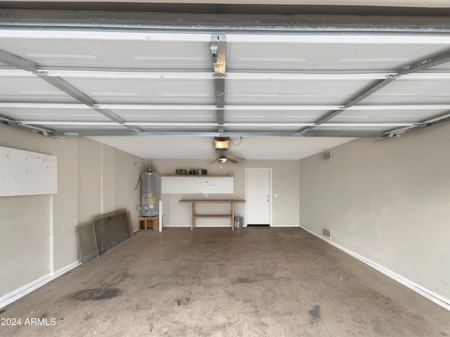 garage with gas water heater and a garage door opener