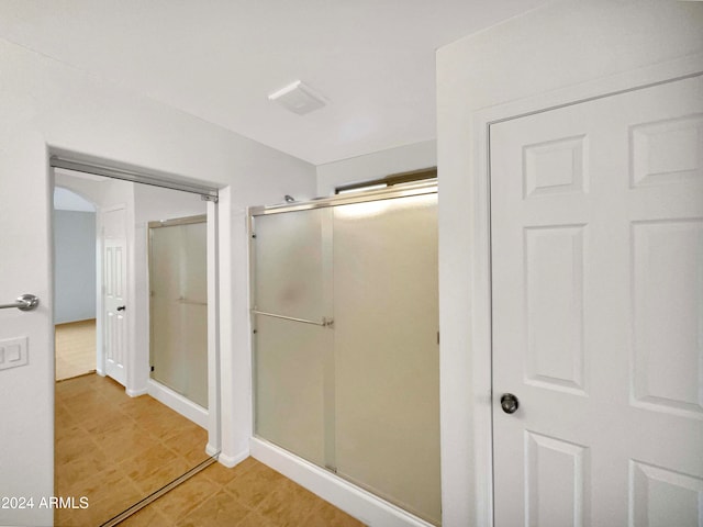 bathroom featuring an enclosed shower