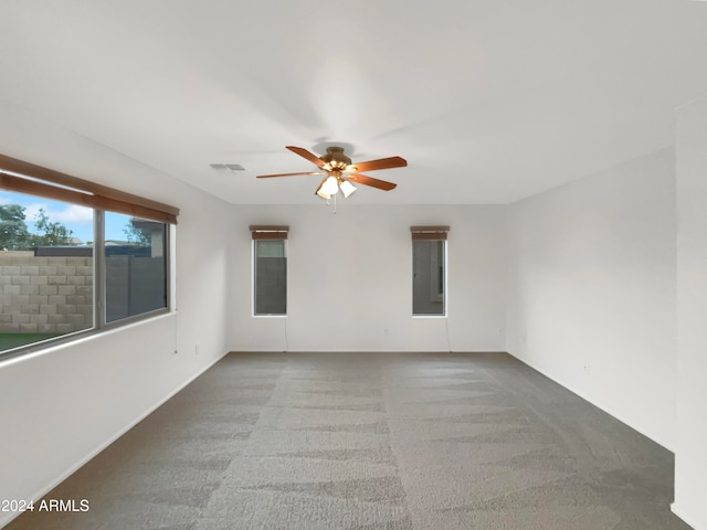 spare room featuring ceiling fan, carpet floors, and electric panel