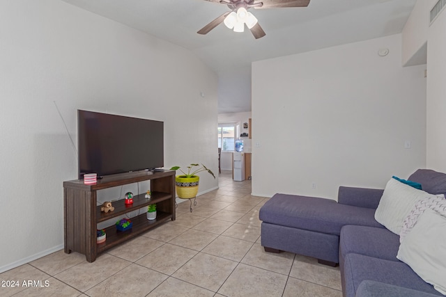 living room with lofted ceiling, ceiling fan, and light tile patterned floors