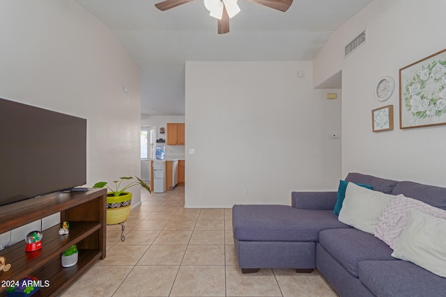 living room with vaulted ceiling, light tile patterned floors, and ceiling fan