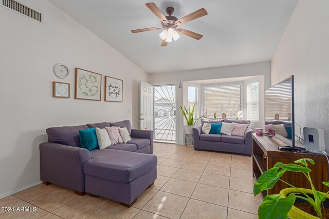 tiled living room featuring ceiling fan and vaulted ceiling