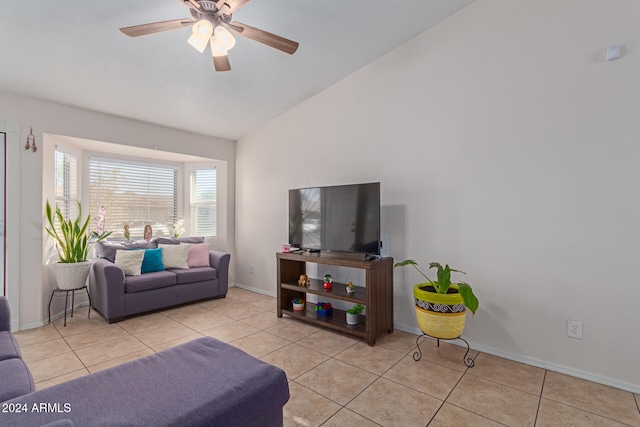 tiled living room featuring ceiling fan and vaulted ceiling