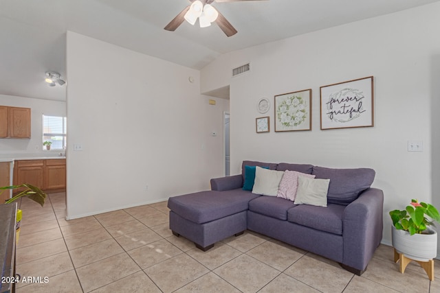 tiled living room with lofted ceiling and ceiling fan